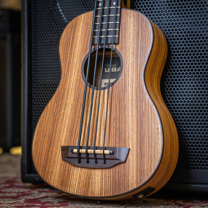 Ubass Kala Zeb-Fs - Bajo Ukulele | El Zebrawood del Ubass Kala Zeb-Fs recibe su nombre y apariencia exótica de las rayas alternas de color canela y marrón oscuro parecidas a una cebra de la veta de la madera. El atractivo Zebrawood ofrece bajos y agudos b