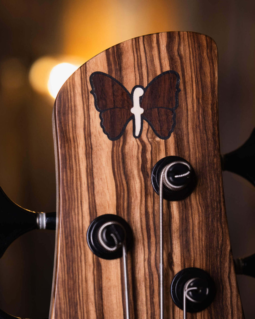 Fodera Monarch 5 Elite 38th Anniversary Zebrawood 2022 - Bajo Eléctrico | Cuerpo • Modelo: Monarch• Madera: Walnut with Alder Tone-Block (Chambered) • Top: Zebrawood• Terminación: Matte Brazo • Madera: 3 Piezas de Hard-Rock Maple• Perfil: Regular• Termina