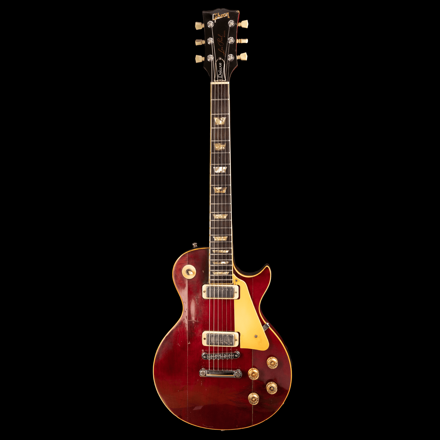 Gibson Les Paul Deluxe Wine Red '79 - $4399990 - Gearhub - First released in 1969, the Deluxe saw the introduction of the mini humbucker™ to the Les Paul lineup. Mini humbuckers retain the hum-free performance of their full-sized cousins but with a somewhat clearer and brighter tonality. The new Deluxe has features that were inspired by those early models from the 1970s, with a non-weight relief mahogany body and bound maple top, a bound mahogany neck with a Rounded C profile, vintage-style Keystone tuners,